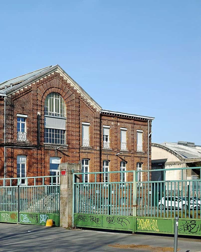 Brick and glass façade of the Gare Saint-Sauveur in Lille, a former railway building turned cultural venue
